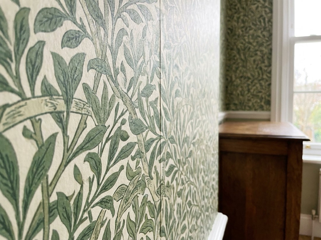 Botanical patterned wallpaper with the pattern matched across a vertical seam